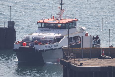 Boat carrying migrants arriving at port.