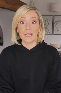 Woman in black hoodie looking at the camera.