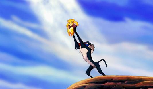 Rafiki lifting Simba as a cub.