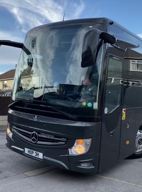Grimsby football team taking a bus to their stadium.
