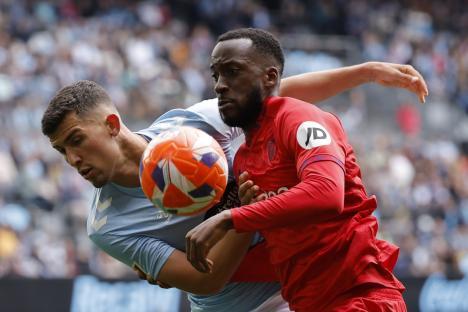 Two soccer players vying for the ball.