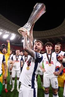 James Maddison of Tottenham Hotspur holding the Europa League trophy.