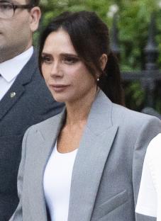 Victoria Beckham in a gray blazer.