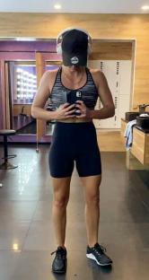 Woman in gym attire taking a selfie.