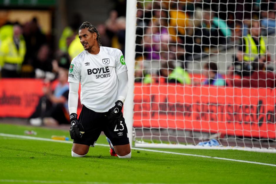 Alphonse Areola, West Ham United goalkeeper, kneeling after conceding a goal.