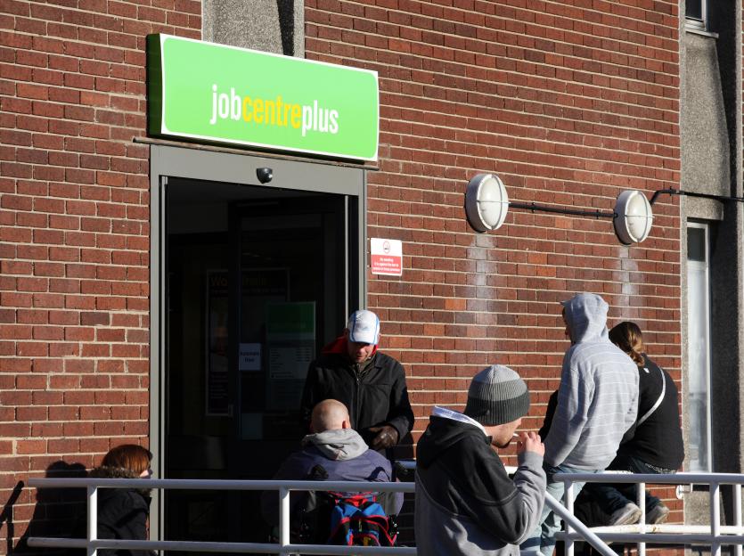 People waiting outside a Job Centre Plus in Nottingham, England.