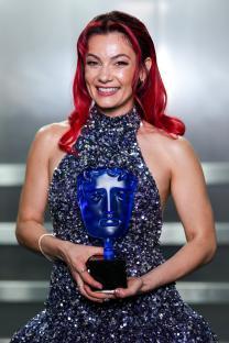 Dianne Buswell holding a BAFTA Television Award.
