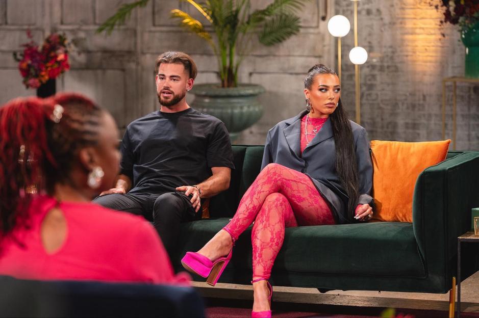 Erica and Jordan from Married at First Sight sitting on a green couch in a televised interview.