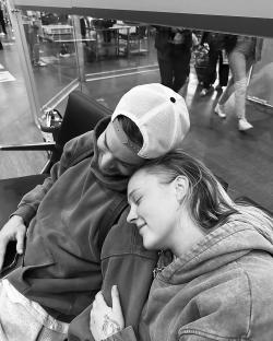 Black and white photo of a couple cuddling.