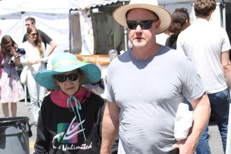 Legendary comedy star, 91, holds hands with younger man in rare public sighting – can you guess who she is?