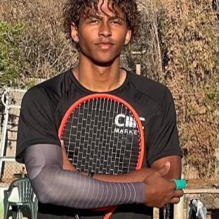 A young man holding a tennis racket.