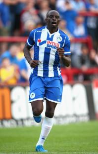 Sanmi Odelusi of Wigan Athletic running during a soccer match.