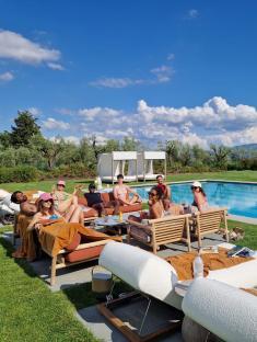 Group of people relaxing by a pool.