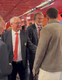 Screenshot of Sir Alex Ferguson shaking hands with another man.