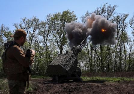 Ukrainian soldier watching Archer self-propelled howitzer fire.