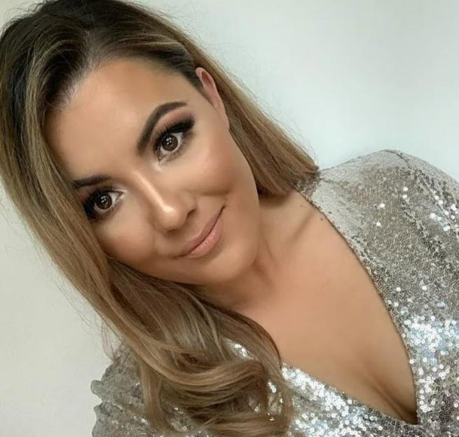 Woman in a sparkly silver dress.