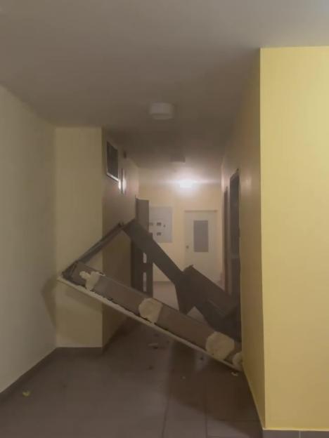 Damage to an apartment hallway from a bomb.
