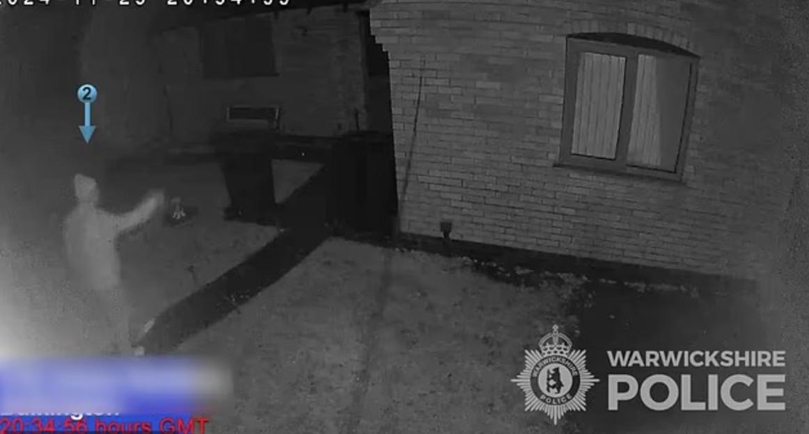 CCTV footage of a man in a backyard.