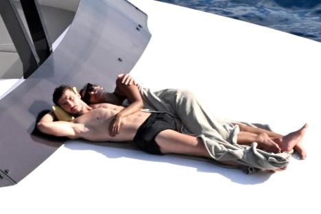 Maya Jama and Ruben Dias cuddling on a yacht.