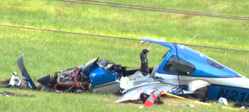 Wreckage of a small blue and white airplane in a grassy field.