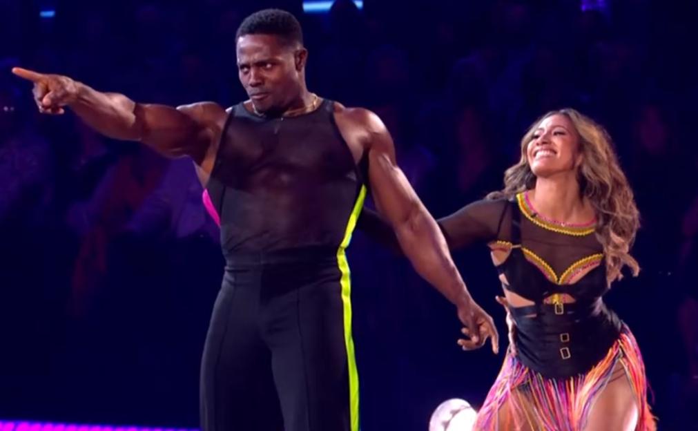 Harry Pinero and Jowita Przystał in colorful costumes dancing.