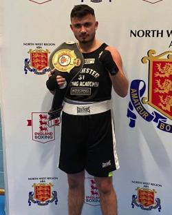 Boxer holding championship belt.