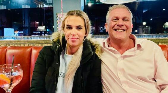 Photo of a father and daughter sitting together.