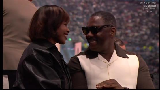 A man and woman smiling at each other.