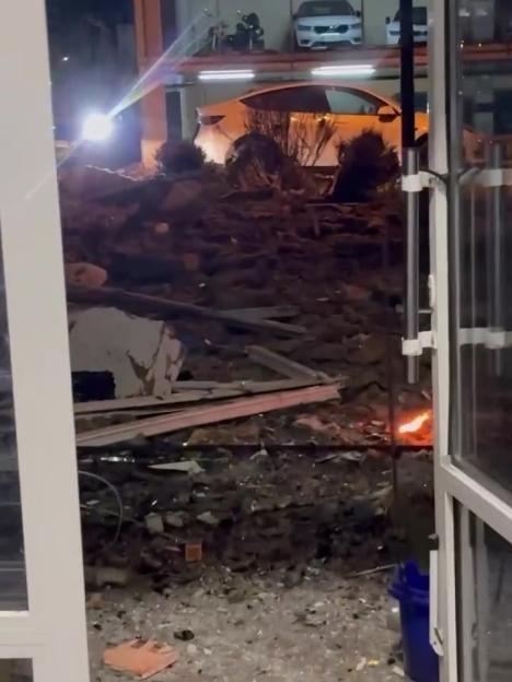 Debris and fire in a bombed Kyiv apartment.