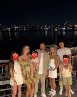 Family photo at night by the water.
