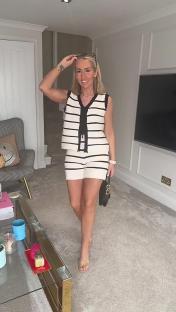 Woman in striped knit shorts and vest set.