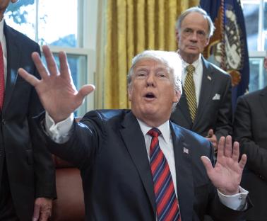 President Trump speaking to the press in the Oval Office.