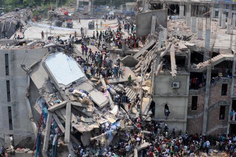 Aerial view of the collapsed Rana Plaza building in Savar, Bangladesh, with many people at the scene.