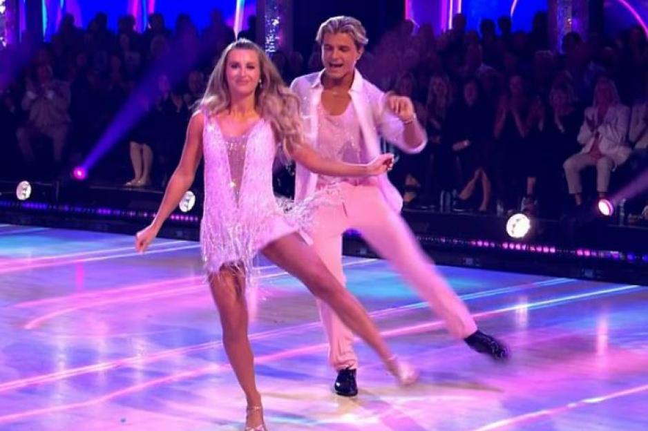 Dani Dyer dancing on Strictly in a pink dress with a male dance partner.