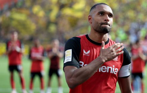 Jonathan Tah of Bayer 04 Leverkusen celebrating with fans.