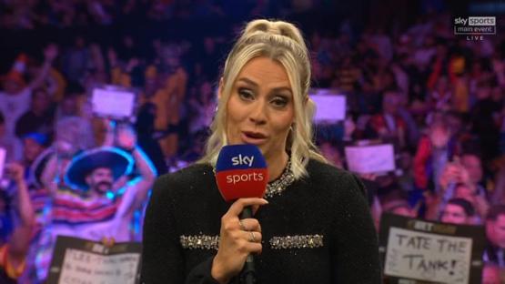 A woman holding a Sky Sports microphone in front of a crowd.