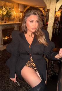 Lauren Goodger in a black cardigan and leopard print shorts.