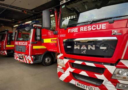 UK fire rescue trucks in a station.