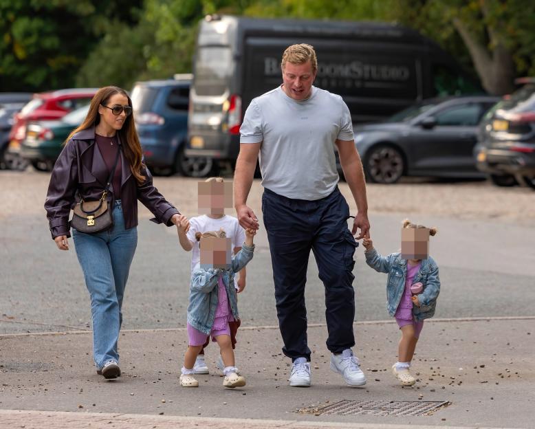 Tom Skinner and wife Sinead holding hands with their children.