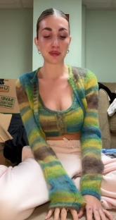 Woman crying while unpacking boxes.