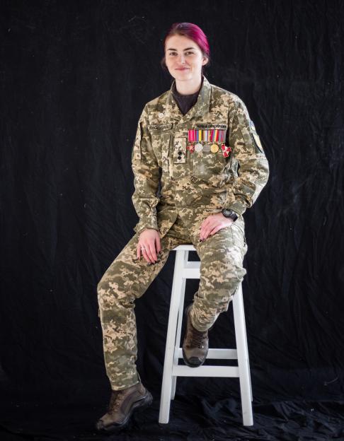 Lieutenant Yulia Mykytenko, a female Ukrainian soldier, sitting in her uniform.