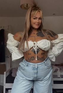Woman with tattoos after breast reduction surgery.