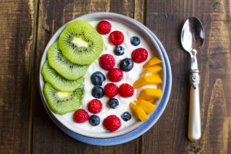 Yogurt bowl with kiwi, raspberries, blueberries, and mango.