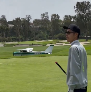 A small plane on a golf course.