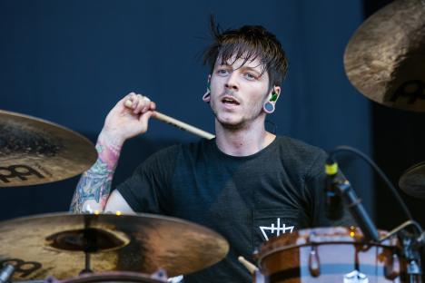 Daniel Williams of The Devil Wears Prada drumming at a music festival.