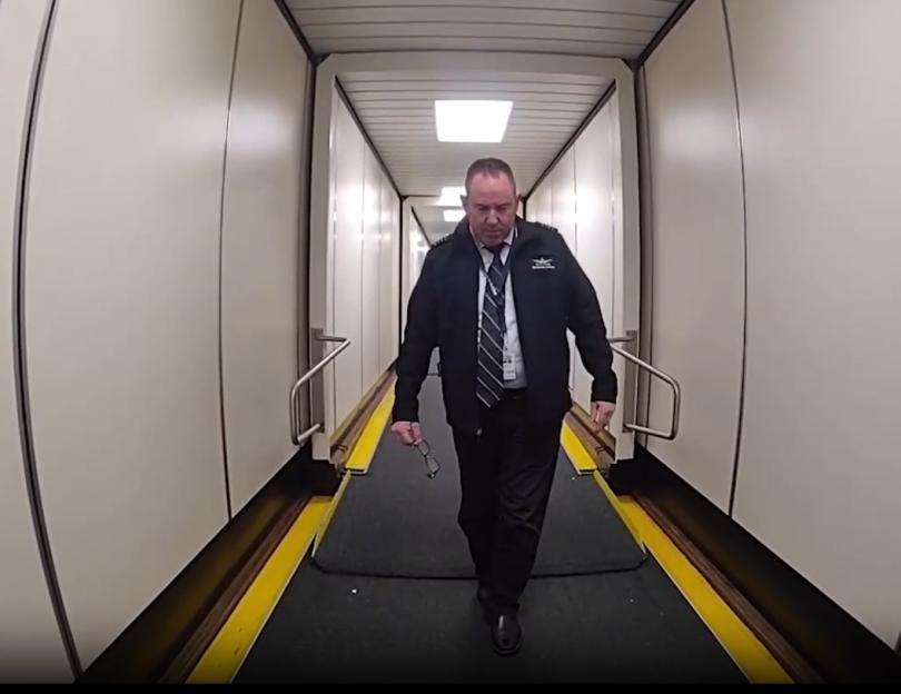 Pilot escorted from plane.