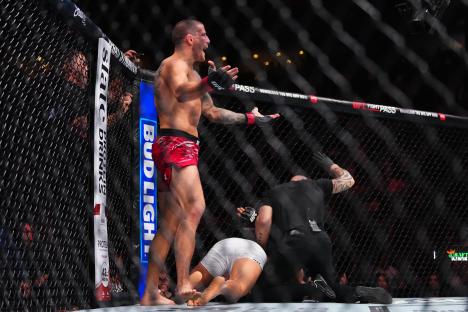 Marc-AndrÃ© Barriault celebrating a knockout victory in a UFC match.