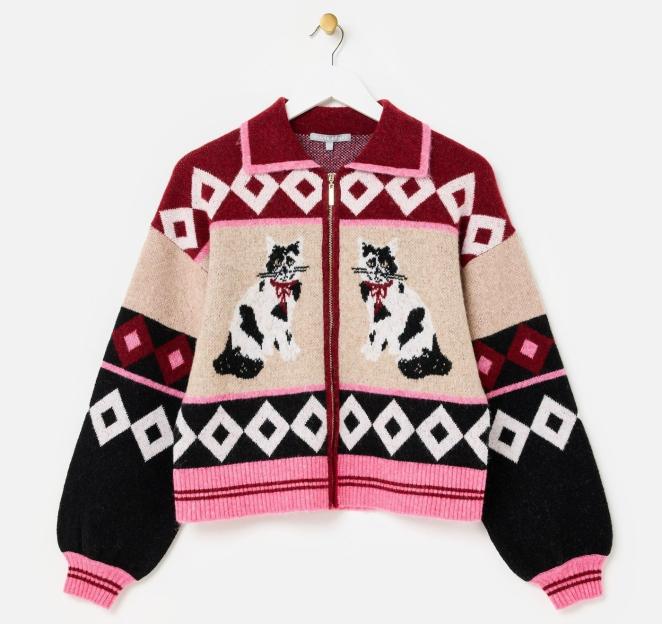 Knitted cardigan with cat design and geometric patterns.