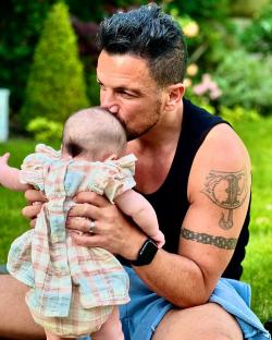 Peter Andre kissing his baby daughter.