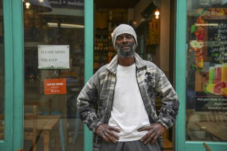 A man standing in front of a shop.